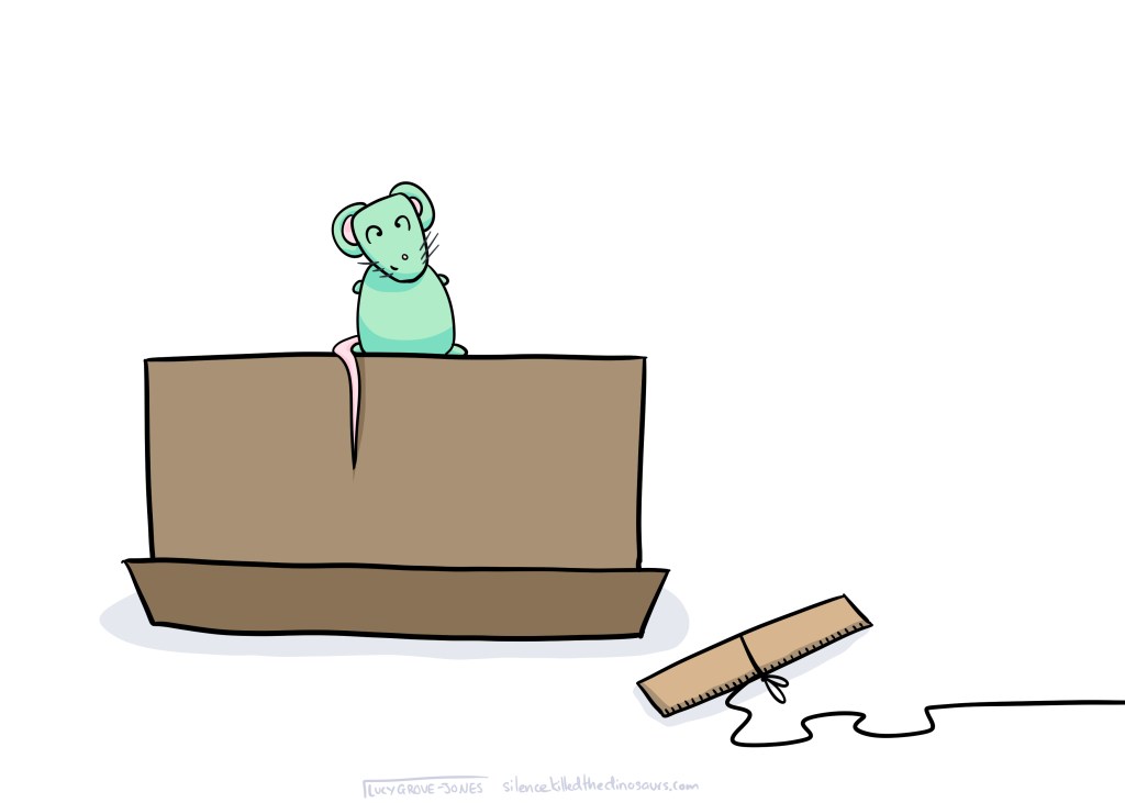 Trap has been sprung. Mouse is sitting on top of box, free.